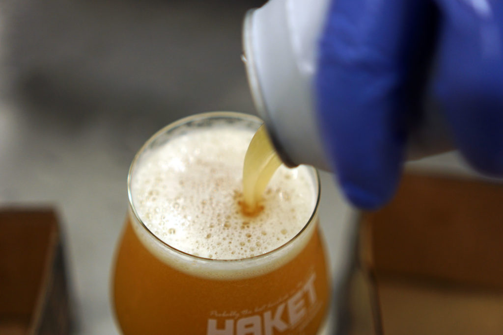 Pouring a can of beer for a tasting in the Beerbliotek Craft Brewery in Sweden.