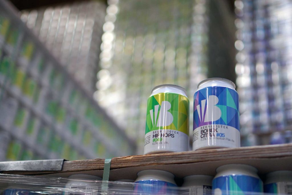 Two empty cans of Beerbliotek Beers, "Hip Hops" IPA and "Bobek Citra" American Pale Ale.