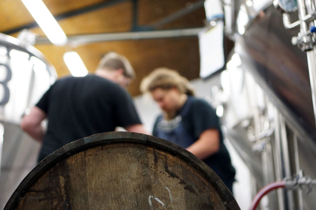 A rum barrel being filled with Oat Stout at the Beerbliotek Brewery.